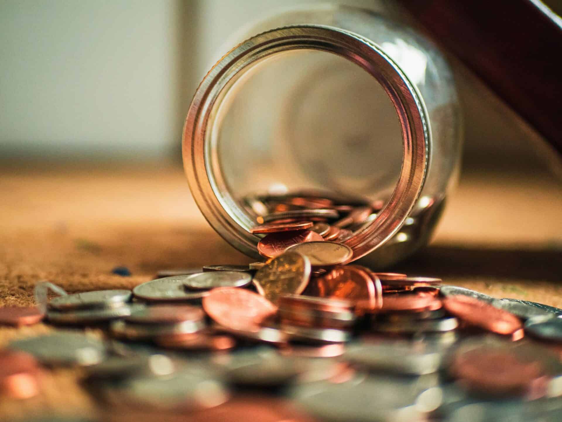 Image of mason jar with coins spilled out